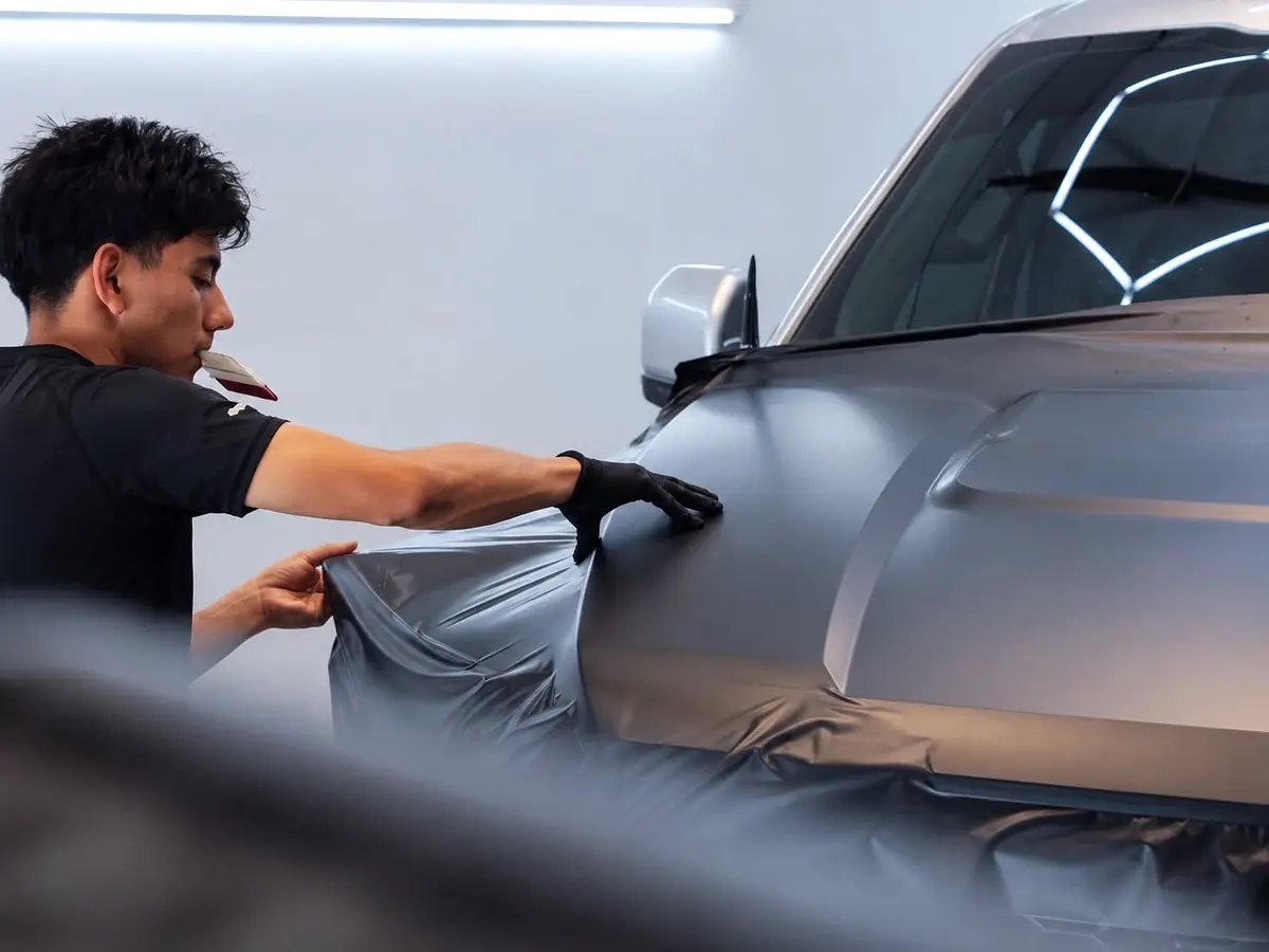 Close view of wrap film being applied to the Ford Raptor