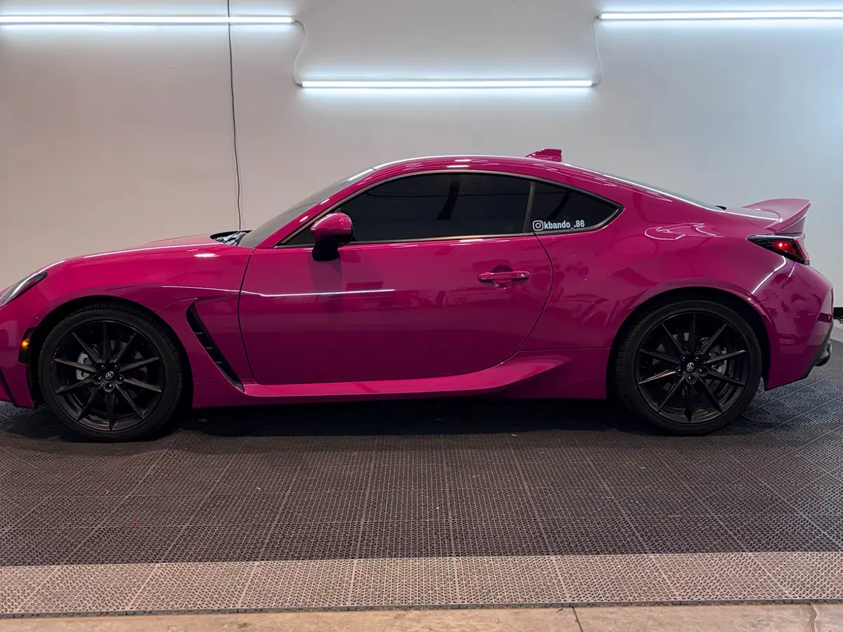 Side profile of pink Subaru BRZ full wrap