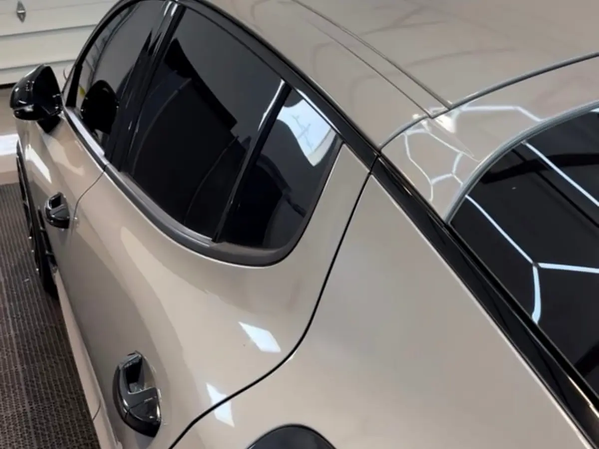 Black window trim chrome delete detail on white Kia